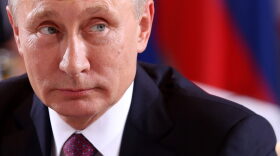 Russian President Vladimir Putin attends a meeting to discuss the Ukrainian peace process at the German federal Chancellery in Berlin, Germany.