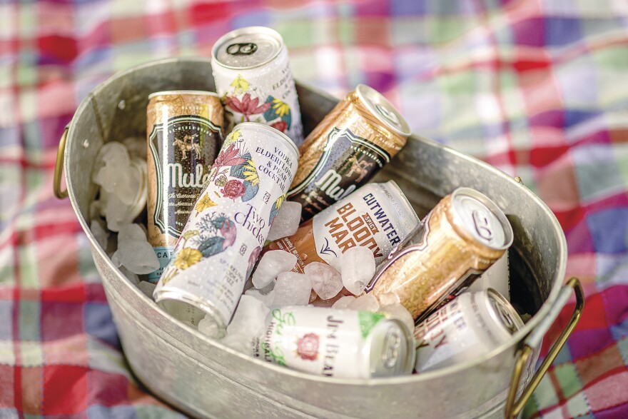  Canned cocktails in an ice pail on a picnic blanket