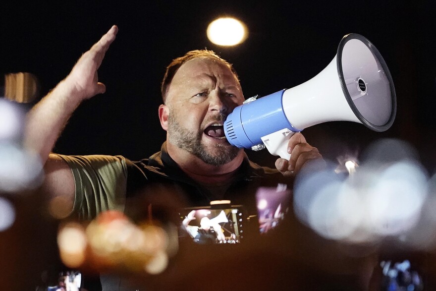 In this Nov. 5, 2020 file photo, radio host Alex Jones rallies pro Trump supporters outside the Maricopa County Recorder's Office, in Phoenix. The U.S. Supreme Court on Monday, April 5, 2021 declined to hear an appeal by the Infowars host and conspiracy theorist, who was fighting a Connecticut court sanction in a defamation lawsuit brought by relatives of some of the victims of the Sandy Hook Elementary School shooting.