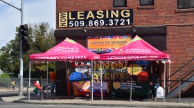 These pink tents are where people can check in for appointments or check walk-in availability.