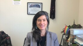 Attorney Natalia Vieira Santanna sitting at her office desk