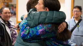 two people hug inside