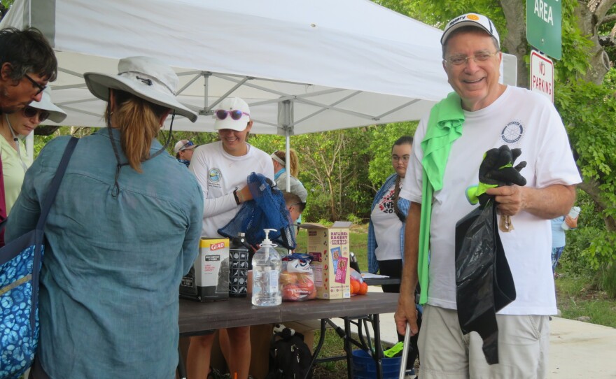 President of the Pinecrest Rotary club, Robert Bull getting equipment for the shoreline trash cleanup.