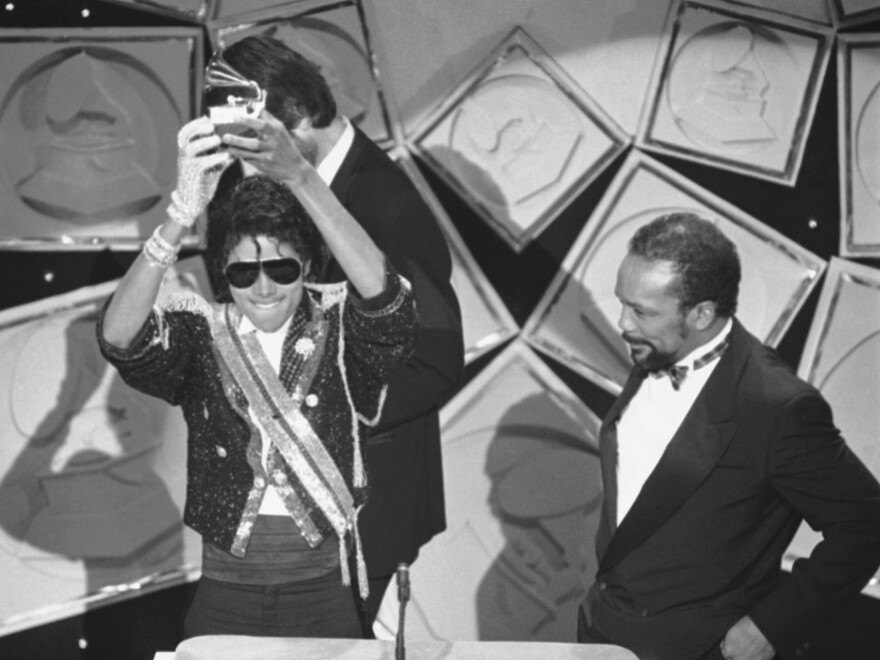 Michael Jackson, left, holds up his Grammy for Best Album of the Year as Quincy Jones looks on, in 1984. Rod Temperton wrote three of the hit songs for Jackson's smash album <em>Thriller</em>.