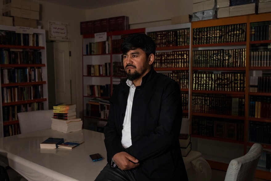 Uighur writer and poet Parach visits a bookshop in Istanbul. "If you stand against China," he says, "you're a threat."