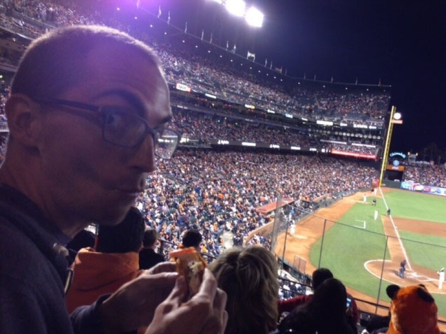 In the sixth inning, Ian realizes there is a baseball game going on around all the food.