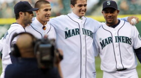 Newly signed Mariners Brad Miller, second from left, and Danny Hultzen, second from right, pose for a photo with Miguel Olivo and Adam Kennedy after they threw out the first pitches Wednesday night at Safeco Field.
