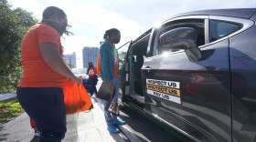 Fast food workers prepare a caravan demonstration near a McDonald's restaurant as they seek higher wages, Friday, Jan. 15, 2021, in Fort Lauderdale, Fla. Workers in 15 cities demonstrated to demand $15/hr from corporations like McDonald's.