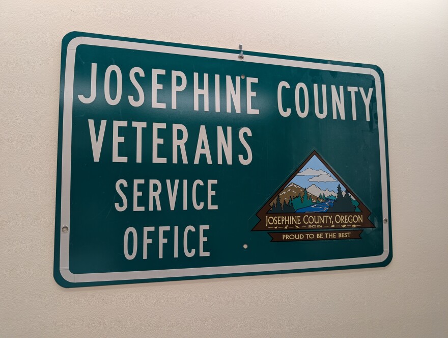 A green sign hanging on a wall that reads, "Josephine County Veterans Service Office."