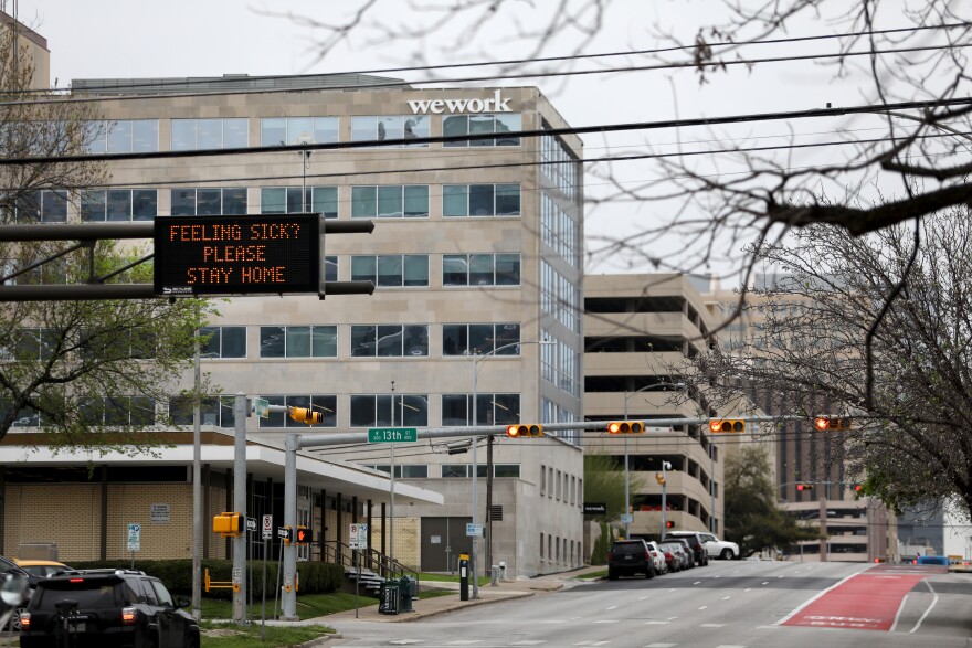 A sign on Guadalupe tells drivers to stay home if they are feeling sick. 