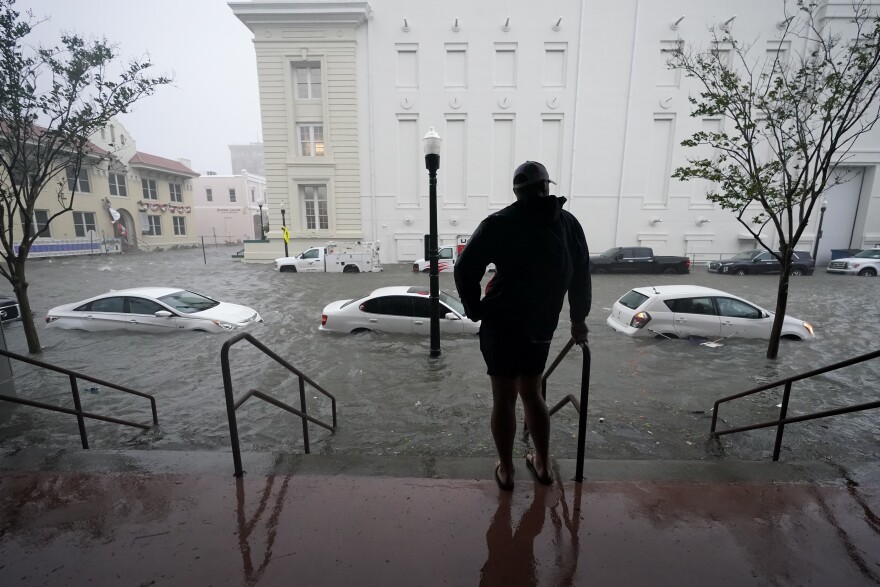 FILE - In this Sept. 16, 2020, file photo, floodwaters move on the street, in Pensacola, Fla. Hurricane Sally made landfall near Gulf Shores, Alabama, as a Category 2 storm, pushing a surge of ocean water onto the coast and dumping torrential rain from the Florida Panhandle to Mississippi and well inland.