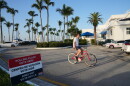 A cyclist rides past a voting precinct at Miami City Hall 