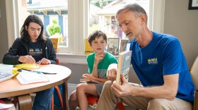 Simon Hand, a children’s librarian, shares his book pick — Jacob Have I Loved by Katherine Paterson — with the middle school book club he runs on July 30, 2026.