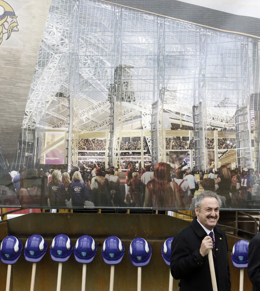 A rendering of the new Minnesota Vikings stadium hangs behind team owner Zygi Wilf at groundbreaking ceremonies for the new stadium on Dec. 3, 2013, in Minneapolis.