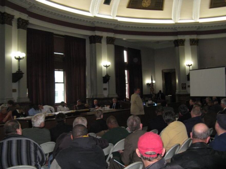 Union president Chris Molitor (in tan jacket) updates the Public Safety committee and others on March 8, 2012 on the progress of negotiations over changes to firefighter pensions.