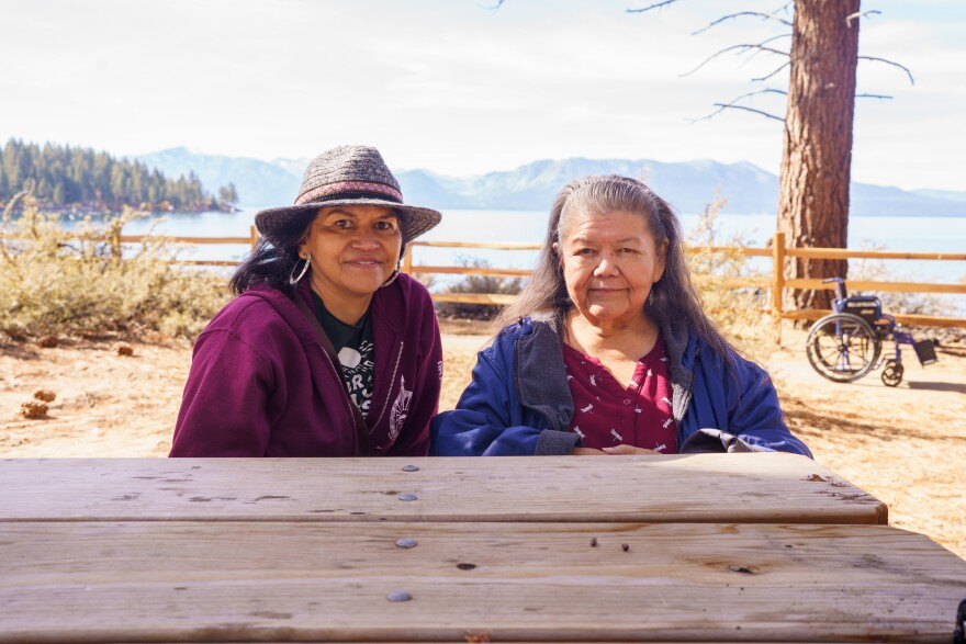 Executive director of the Washoe Warrior Society nonprofit, Lisa Grayshield (left) and founding elder of the society, Melba Rakow (right) sit at a picnic table in front of Lake Tahoe on the shores of Zephyr Cove.