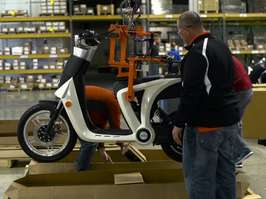Workers at Mahindra's Ann Arbor, Mich., factory load up a new GenZe for shipping to the initial markets of the San Francisco Bay Area and Portland, Ore.