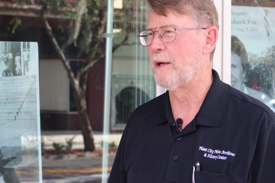 Gil Gott, Executive Director of the Plant City Photo Archives and History Center, talks to a USF student journalist outside of the Archives.