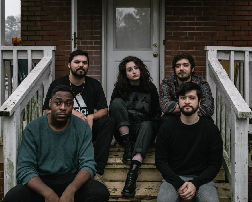 Petrov's Mary Grace McKusick, Mike Backlund, Syd Little, Garrett Herzfeld and Matt McConomy sit on a Charlotte stoop.