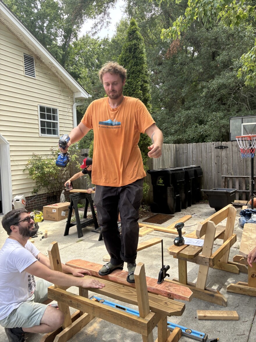 A DSA member jumps up and down on a newly constructed bench to test its stability.