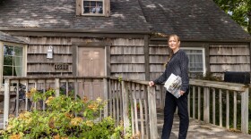 Council member Inga Selders stands at her childhood home, where she lives in Prairie Village, Kan. Selders stumbled upon a racially restrictive housing covenant in her homeowners association property records. She's working to remove it<strong> </strong>but has faced pushback from other council members, as they think amendments to these covenants suffice and removing them would be removing history.