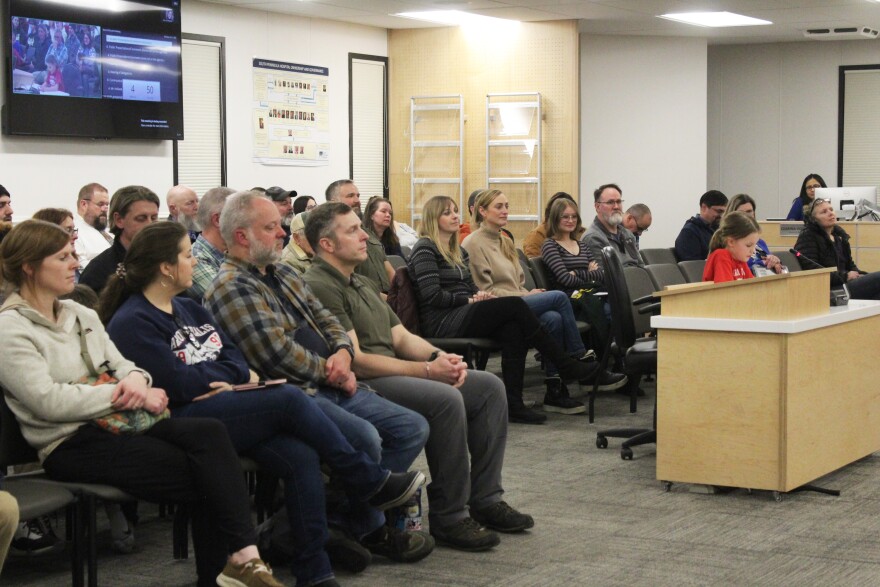 School board meeting attendees listen to Briar Oden testify in favor of a high school program for Aurora Borealis Charter School on Monday, Feb. 2, 2026 in Soldotna, Alaska.