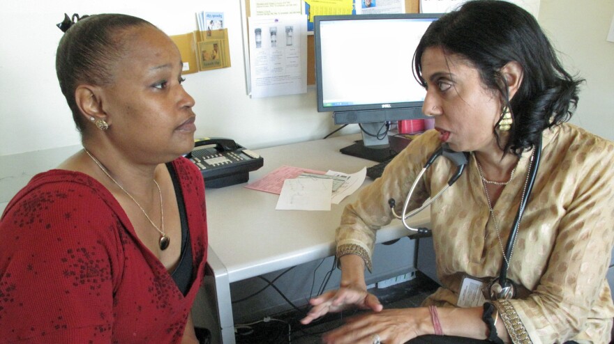 HIV patient Darnell Hollie, 47, talks to her doctor Monica Gandhi (right) at San Francisco General Hospital. Her path from drug addict to model patient was "a lot of work, but if you want it, it's there for you," Hollie says.