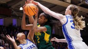 Baylor's Kiersten Johnson (2) grabs a rebound between Duke's Delaney Thomas (12) and Duke's Toby Fornier (35) during the first half in the second round of the NCAA college basketball tournament, Sunday, March 22, 2026 in Durham, N.C.