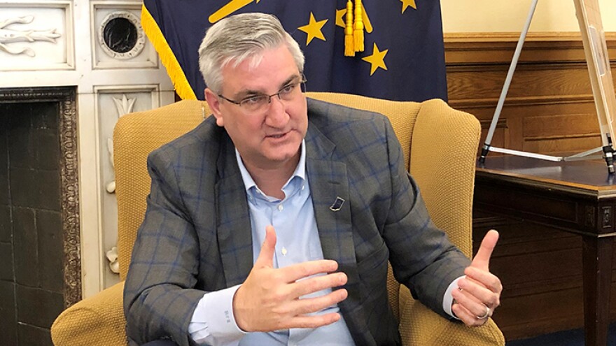 Indiana Gov. Eric Holcomb speaks with reporters about the state's coronavirus response on Friday, March 13, 2020, at his Statehouse office in Indianapolis.