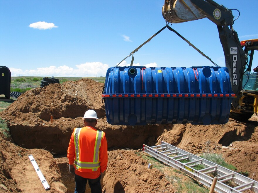 Indian Health Service workers install a septic system.