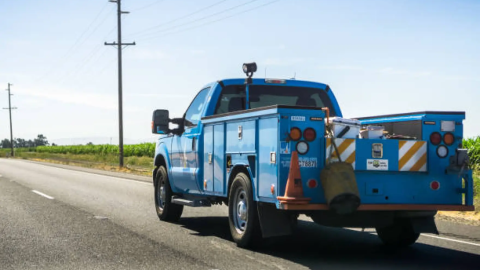 A PG&E service vehicle driving on the freeway