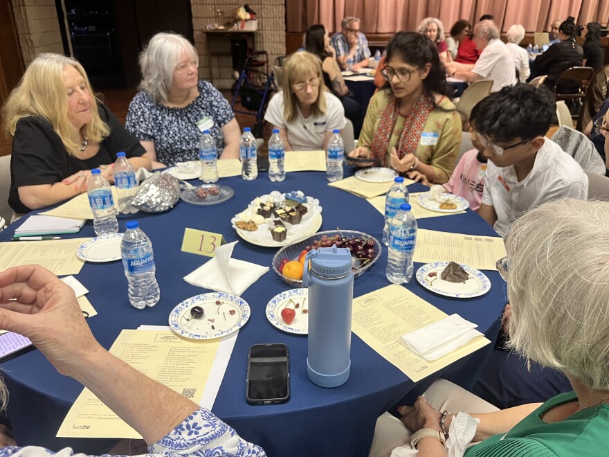 Shivani Patel, center right, discusses a Sanskrit prayer that she was reminded of while discussing "America the Beautiful."