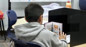 A student reads a graphic novel at Hills Elementary in Santa Fe South Charter Schools on Aug. 4 in Oklahoma City.