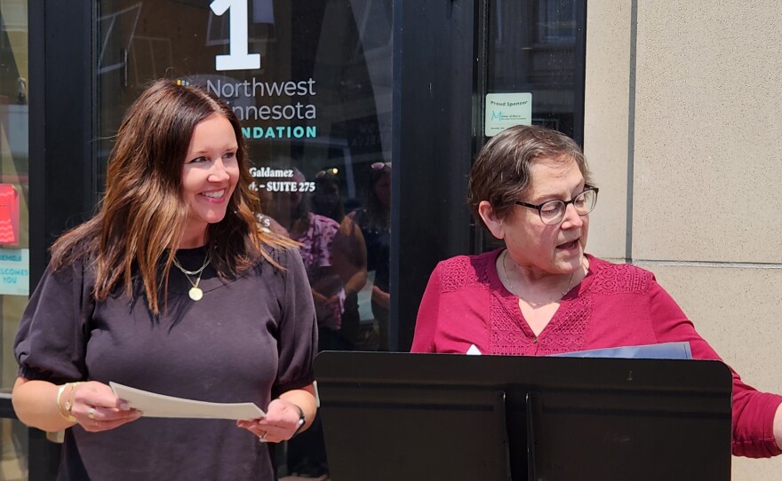 Ashley Johnson and Chris Bell from the Northwest Minnesota Foundation share the story of their building's origin in the last century as the Charley Miles Block during a Bemidji Heritage Preservation Commission ceremony on June 11, 2025.