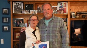 Mary Karol Matchett, with her husband Doug, hold a photo of thier son Scott while on a dive with Doug in the Flordia Keys. Scott, who is deaf, had trouble communicating with police while experiencing metal heath crisis because an interpreter was never provided by the police department.(photo by Max Schulte)