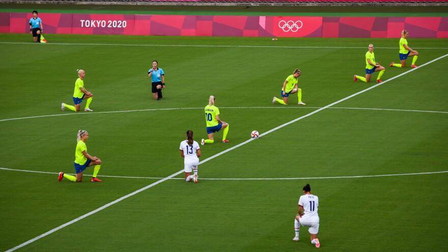 Players take the knee ahead of an opening round women's football match between the U.S. and Sweden at the Tokyo 2020 Olympic Games in Tokyo, Japan, on Wednesday, July 21, 2021. The games will be the first in modern history to be held without spectators, after Tokyo entered another state of emergency that will run throughout the tournament. Photographer: Noriko Hayashi/Bloomberg via Getty Images