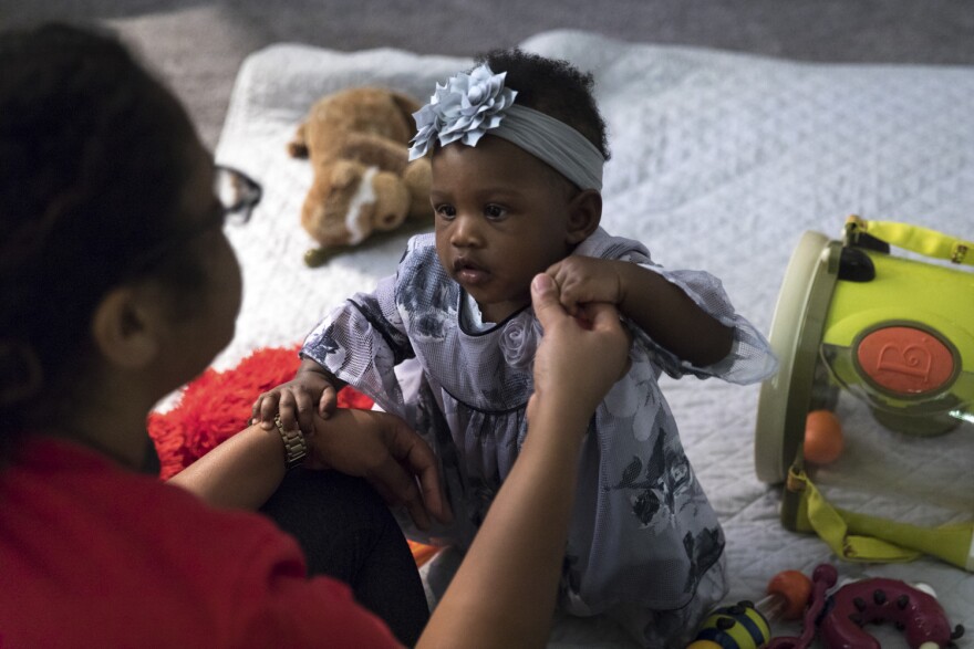 Soleil plays with her nanny.