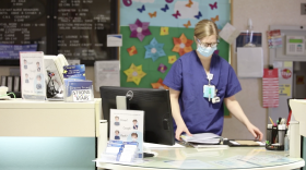 A nurse organizes papers at a nurse's station at the University of Rochester Medical Center on April 9, 2020.