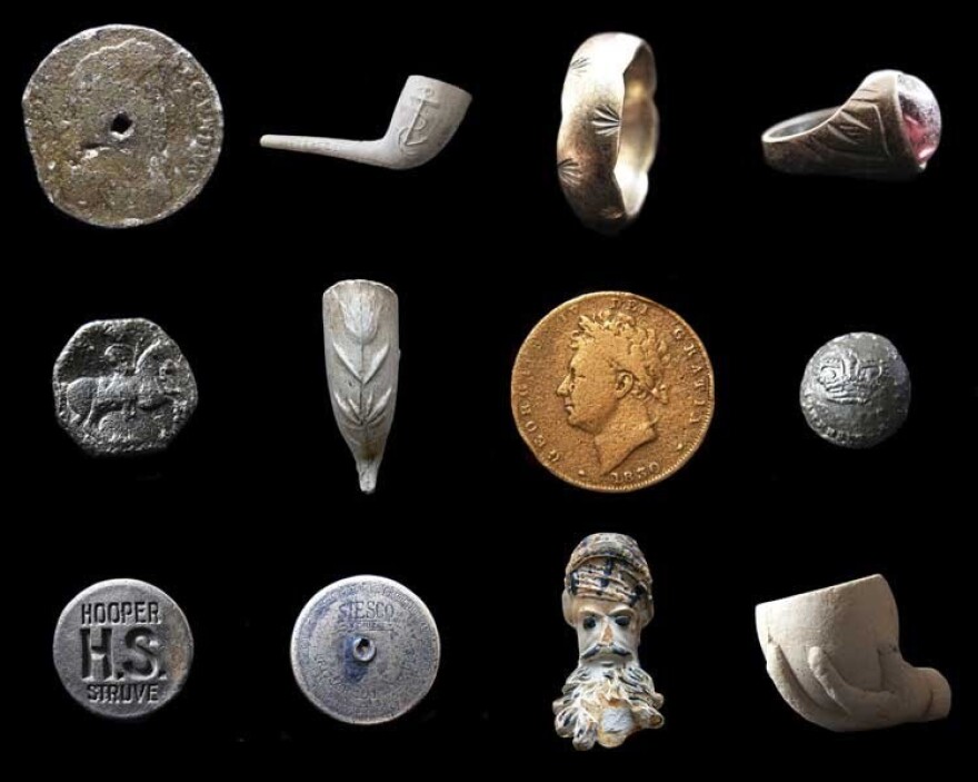 Found objects from the Thames. Top row: a 1687 tin halfpenny, a Victorian clay pipe, a gold ring, a Victorian ring. Middle row: a decorated medieval button, a Victorian clay pipe, an 1830 George IV farthing, a Georgian military button. Bottom row: a Hooper Brewery stopper, a sailor's bag lock, a French Jacob pipe bowl and a child's toy clay pipe bowl. <em>Note: objects not to scale.</em>