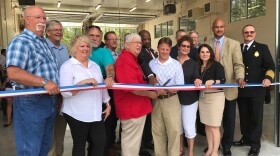 “County and city officials gathered together in Waldo to cut the ribbon for the new Alachua County Fire Station. Mayor Louie Davis (left) and Project Coordinator Bryan Schneider (right) hold the scissors together.” (Morgan Rynor/WUFT)
