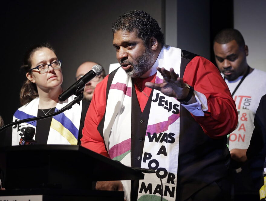 The Rev. Dr. William J. Barber II, center, and Rev. Dr. Liz Theoharis, left, co-chairs of the Poor People's Campaign, speak at the National Civil Rights Museum Tuesday, April 3, 2018, in Memphis, Tenn. They announced the campaign is preparing for 40 days of non-violent "direct action" in about 30 states that will climax with a rally in Washington this June. The organization is the rekindling of the campaign to help poor people that the Rev. Martin Luther King Jr. was working on when he was killed April 4, 1968, in Memphis. (AP Photo/Mark Humphrey)
