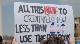 Connor Montgomery, of Manhattan, holds a sign as part of a Trans Day of Visibility demonstration March 31, 2026, outside the Kansas Statehouse.