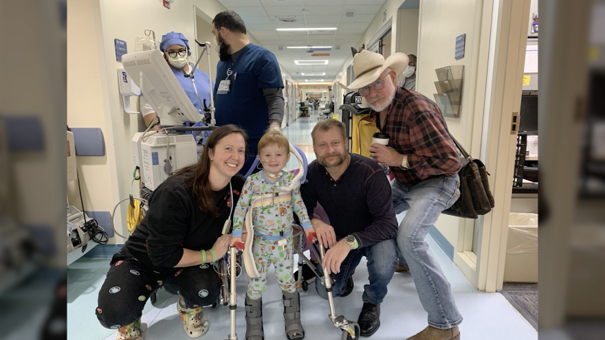 Catherine Clark (left) poses for a picture alongside her son, Carl Alford, plus his father and grandfather as Carl practices walking while recovering from severe sepsis.