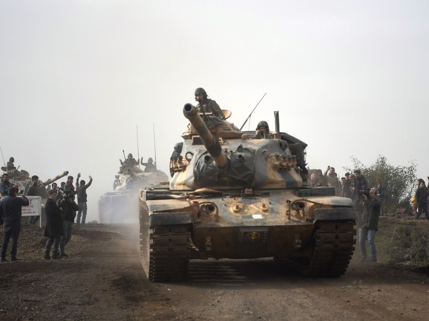 Turkish army tanks head to Afrin, an enclave in northern Syria controlled by U.S.-allied Kurdish fighters, on Monday.