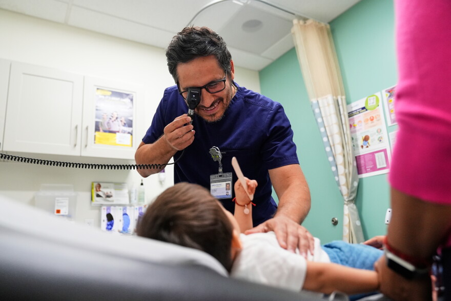 FILE - Pediatrician Irving Phillips examines a 16-month-old boy at a CommuniCARE+OLE clinic, June 26, 2025, in Davis, Calif. (AP Photo/Godofredo A. Vásquez, File)