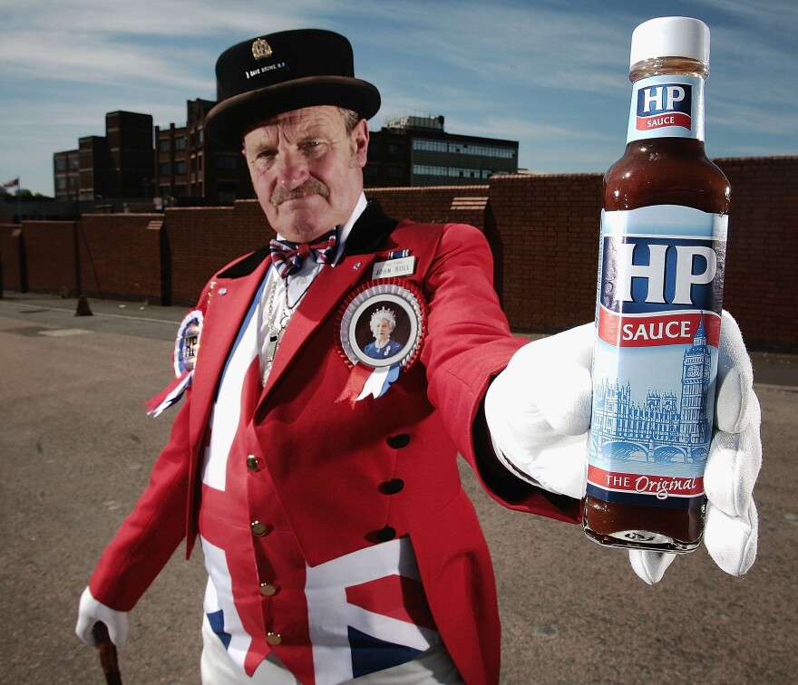John Bull alias Ray Egan poses with a bottle of HP sauce as workers from Birmingham's HP Sauce company protest outside the factory against closure on June 3, 2006, in Birmingham, England. The HP Foods factory in Birmingham is to close and production of its famous sauce moved to Holland. HP which stands for Houses of Parliament is an iconic British brand.