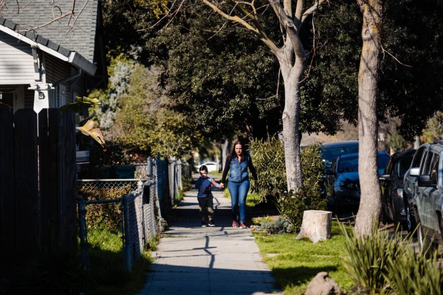 A mother and son walk through Stockton, California.