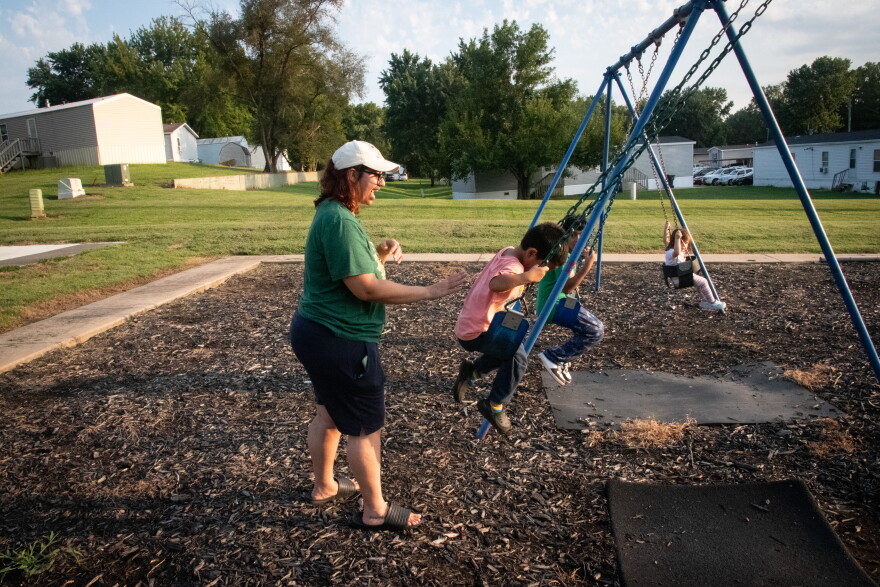 Chalé Turner of Topeka, Kansas, pushes her children on the swings. Turner says her identity played a role in her decision to give birth unassisted. Turner’s father is Black and her mother is white and Ojibwe. “My weariness of hospitals and the medical system doesn’t come from nowhere. It comes from being a person of color, from being a Black person and having very Black parent, you know, a Black father and very proud Black grandparents who saw the Civil Rights Movement,” she says.