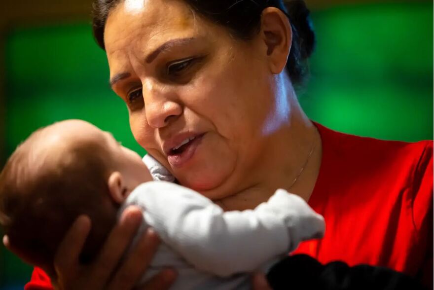 Diana Garcia smiles at her grandson in her daughter’s home in Kingwood.