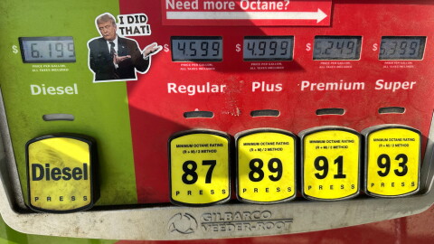 A sticker placed by an unidentified person depicting President Donald Trump and reading "I DID THAT!" is affixed beside gasoline and diesel prices at a gas station in Newtown, Pa., Wednesday, Sept. 9, 2026, as rising pump prices test Trump's campaign pledge to cut energy costs in half. 